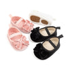 Front Bow velvety baby shoes, available in black and pink.