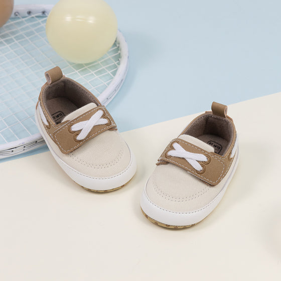 Cream canvas and pleather baby shoes. CG5167