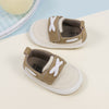 Cream canvas and pleather baby shoes. CG5167