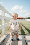 Beige t-shirt with duck applique and camouflage shorts. SOL