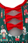 Nutcracker printed girls dress with red ruffle hem and open back with bows. DRG65443 AMY