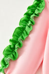 Lt. Pink Christmas character holding a bow and ruffle hem on sleeves. TPG60756 BRE