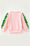 Lt. Pink Christmas character holding a bow and ruffle hem on sleeves. TPG60756 BRE