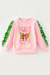 Lt. Pink Christmas character holding a bow and ruffle hem on sleeves. TPG60756 BRE