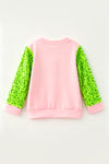 2 Bows & Christmas character printed on Lt. Pink top with green sequins sleeves. TPG60768 BRE