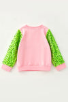 Extra Grin--chy character printed pink top with green sequins sleeves. TPG60770 AMY