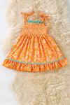 Orange ditsy floral w/mauve green ruffle trim smock dress. DRG60499 SOL