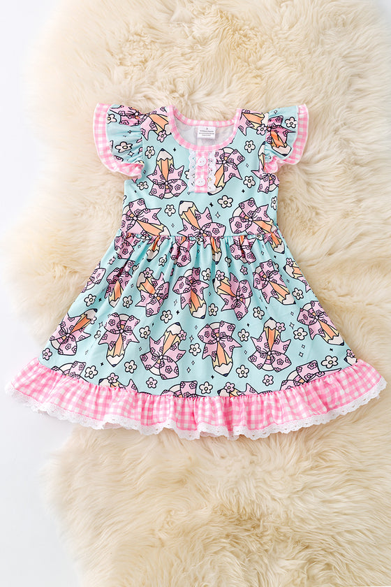 Coquette pencil printed on aqua color dress with gingham ruffle trim DRG51157