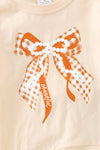 Pearl Bow printed on cream sweatshirt w/ ruffle and rust orange bell bottoms. OFG61417 SOL
