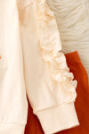 Pearl Bow printed on cream sweatshirt w/ ruffle and rust orange bell bottoms. OFG61417 SOL