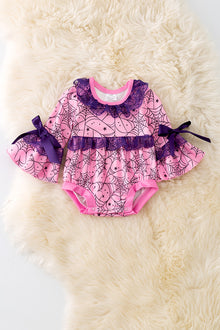 Spider web printed on pink baby onesie with purple lace and bell sleeves. RPG50951 SOL
