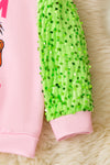 Team Grinch" Pink sweatshirt with green sequins sleeves. TPG51373 AMY