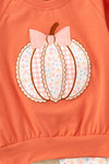 Pumpkin printed applique  on orange sweatshirt with ruffle hem & floral pants. OFG61732 AMY