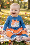 Blue top w/white polka dot & ruffle hem and orange pants. OFG61765 JEAN