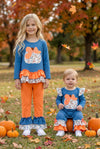 Blue top w/white polka dot & ruffle hem and orange pants. OFG61765 JEAN