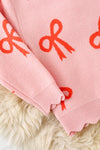 Coral bow on pink pullover knit sweater w/ scalloped hem. TPG60463 AMY