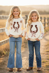 Horse shoe on cream knot pullover sweater w/moon stitch. TPG60491 SOL