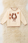 Horse shoe on cream knot pullover sweater w/moon stitch. TPG60491 SOL