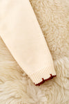 Horse shoe on cream knot pullover sweater w/moon stitch. TPG60491 SOL