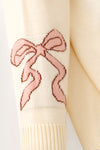 Horseshoe knit sweater w/ pink bow on sleeves. TPG60533 JEAN