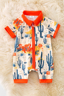  (Western) Dry dessert on cream printed baby romper with orange trim. RPB50321 Jean