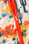 (Western) Dry dessert on cream printed baby romper with orange trim. RPB50321 Jean