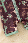 Bull skull & cactus printed on brown baby romper with green trim. RPB50494 JEAN