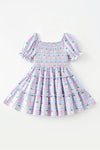 Blue gingham w/ pumpkin printed smocked tiered dress. DRG65299 SOL