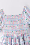Blue gingham w/ pumpkin printed smocked tiered dress. DRG65299 SOL