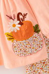 Lt. Coral tunic with pumpkin applique and floral leggings. OFG61931 SOL