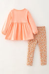 Lt. Coral tunic with pumpkin applique and floral leggings. OFG61931 SOL