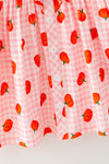 Pumpkin printed on pink gingham ruffle dress. DRG64473 SOL