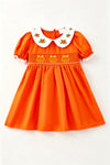 Orange smocked dress with embroidered pumpkin. DRG64521 AMY