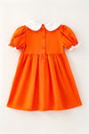 Orange smocked dress with embroidered pumpkin. DRG64521 AMY