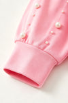 Pink "Merry Christmas printer sweatshirt with clipped pearls on sleeves. TPG60701 AMY