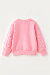 Pink "Merry Christmas printer sweatshirt with clipped pearls on sleeves. TPG60701 AMY
