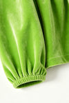 Green faux velvety tunic and red pants. OFG63380 MON
