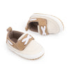 Cream canvas and pleather baby shoes. CG5167