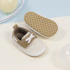 Cream canvas and pleather baby shoes. CG5167