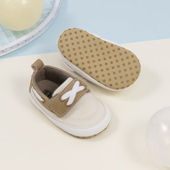 Cream canvas and pleather baby shoes. CG5167
