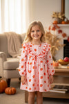 Pumpkin printed on pink gingham ruffle dress. DRG64473 SOL