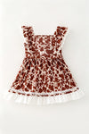 Brown cow printed dress with lace hem and front bow. DRG64467 AMY