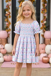 Blue gingham w/ pumpkin printed smocked tiered dress. DRG65299 SOL