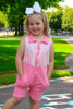Pink Romper with side pockets and fringe.