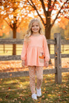 Lt. Coral tunic with pumpkin applique and floral leggings. OFG61931 SOL