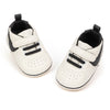 Off white infant tennis shoes with velcro. PT5111N