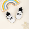 Off white infant tennis shoes with velcro. PT5111N