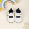 Off white infant tennis shoes with velcro. PT5111N