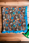 CONCHO, CACTUS & COW SKULL PRINTED BABY BLANKET W/ TURQUOISE TRIM. (35"BY 35") BKG25153010