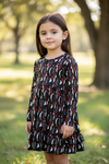 Black multi-printed girls dress with ruffle hem.
